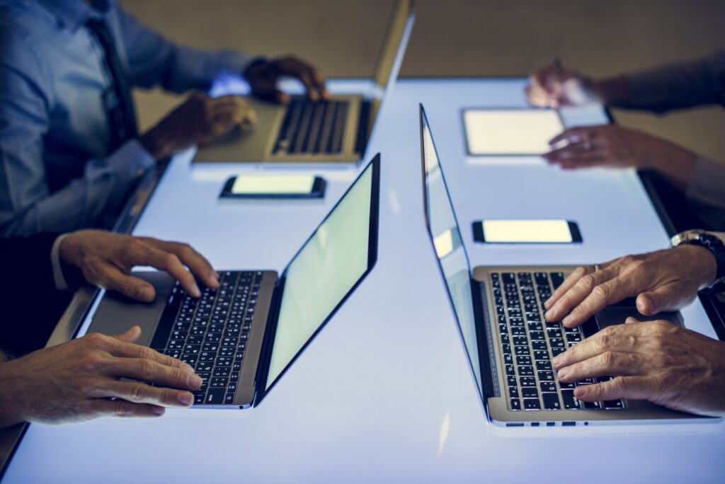 Hand on a laptop working at cyber space table